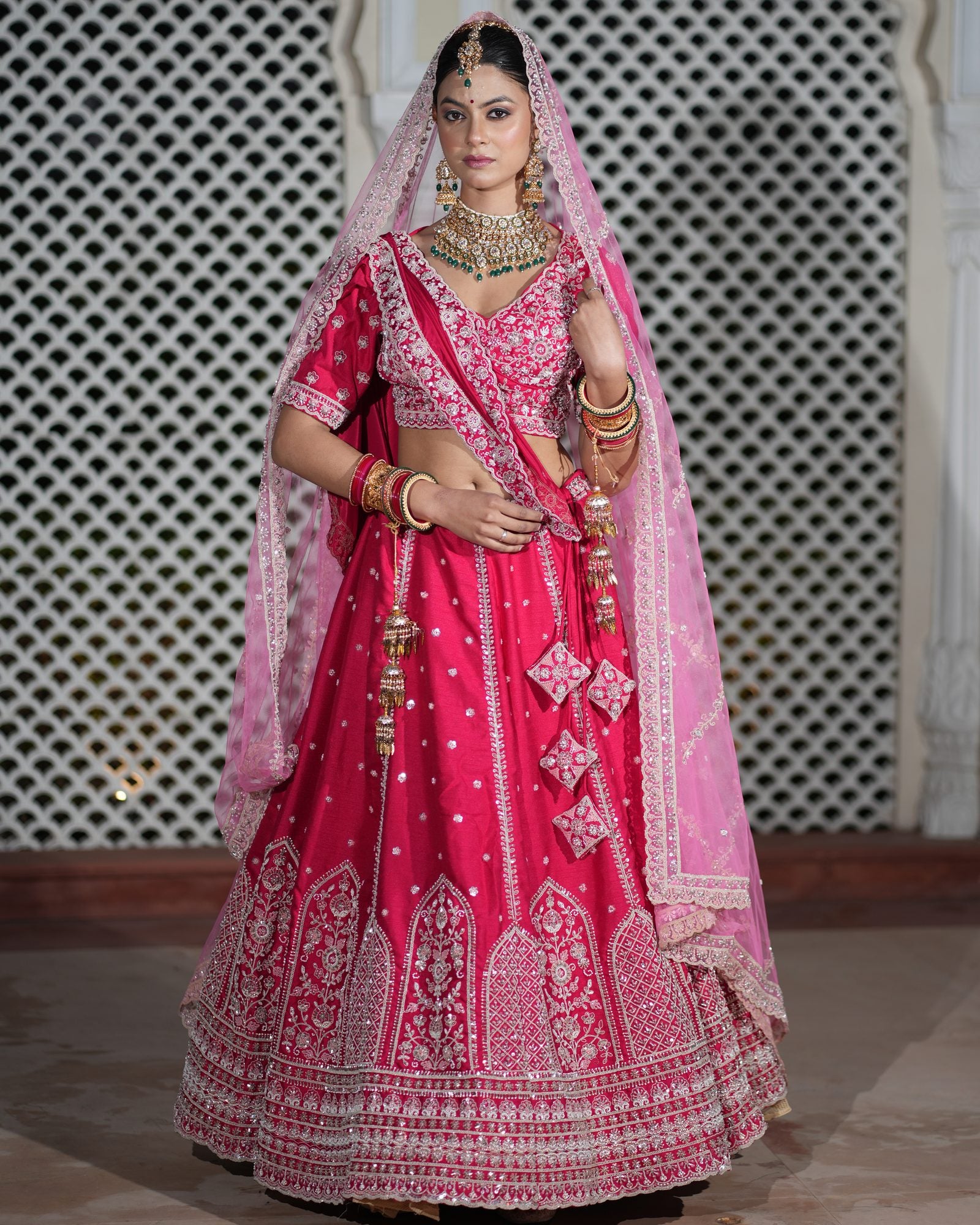 Motif Pattern Embroidered Semi- Sticth Rani Pink Silk Bridal Lehenga Choli with Net Dupatta