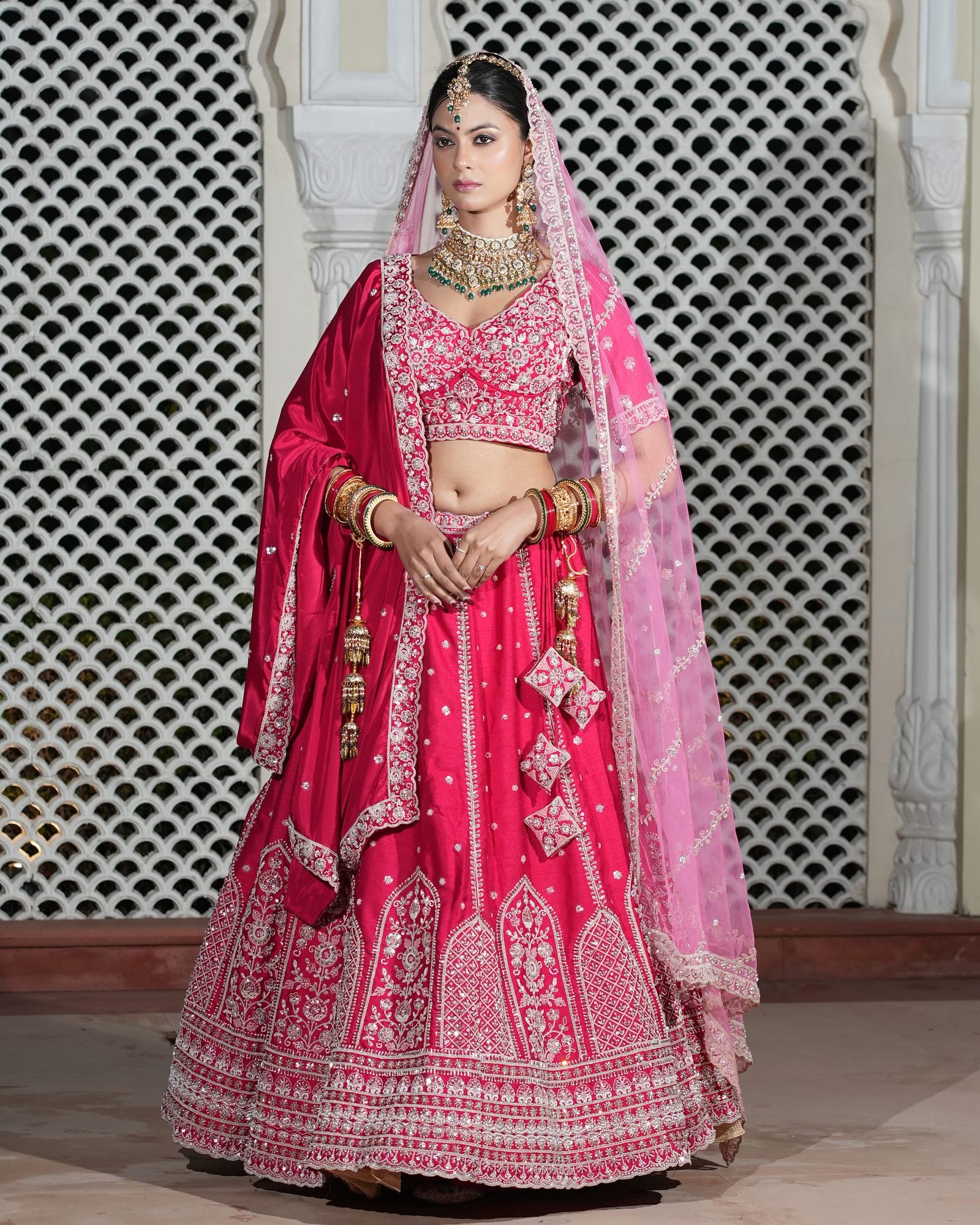 Motif Pattern Embroidered Semi- Sticth Rani Pink Silk Bridal Lehenga Choli with Net Dupatta