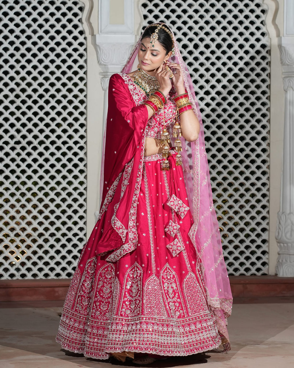 Motif Pattern Embroidered Semi- Sticth Rani Pink Silk Bridal Lehenga Choli with Net Dupatta