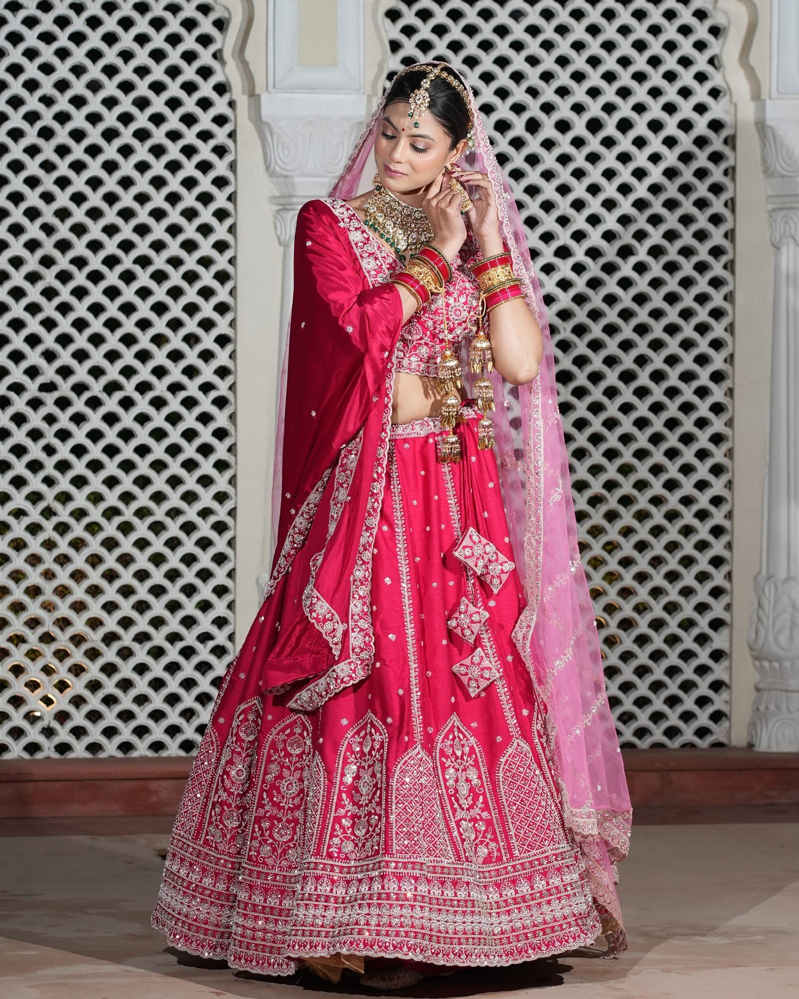 Motif Pattern Embroidered Semi- Sticth Rani Pink Silk Bridal Lehenga Choli with Net Dupatta