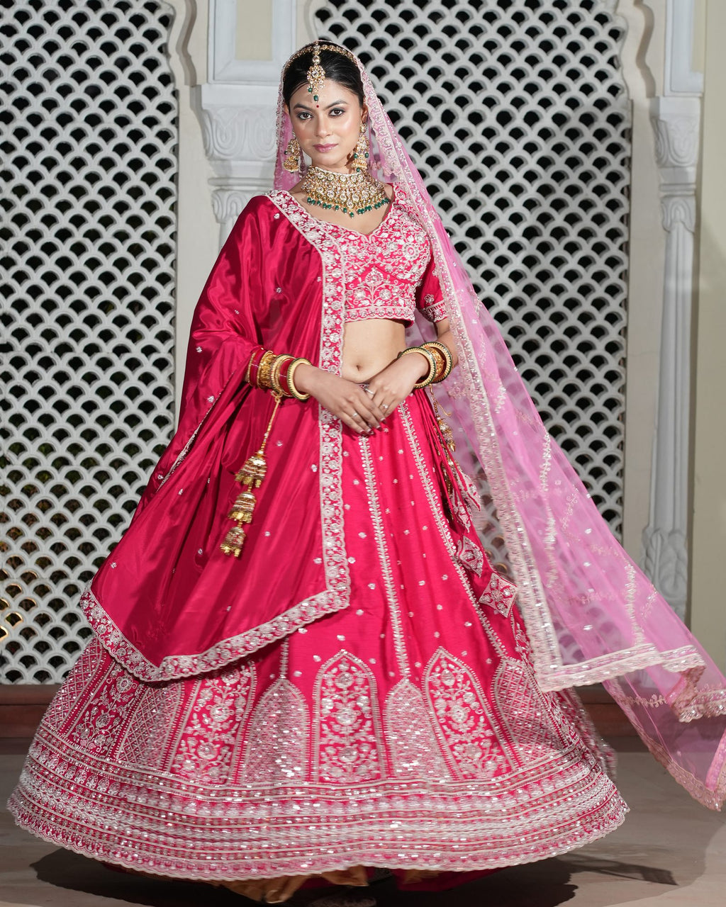 Motif Pattern Embroidered Semi- Sticth Rani Pink Silk Bridal Lehenga Choli with Net Dupatta