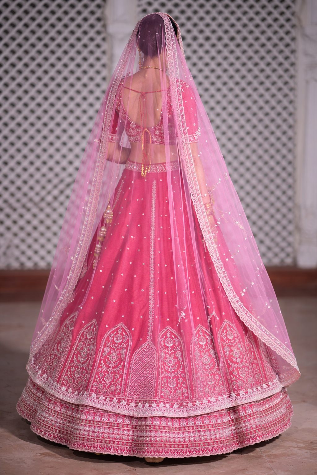 Motif Pattern Embroidered Semi- Sticth Rani Pink Silk Bridal Lehenga Choli with Net Dupatta